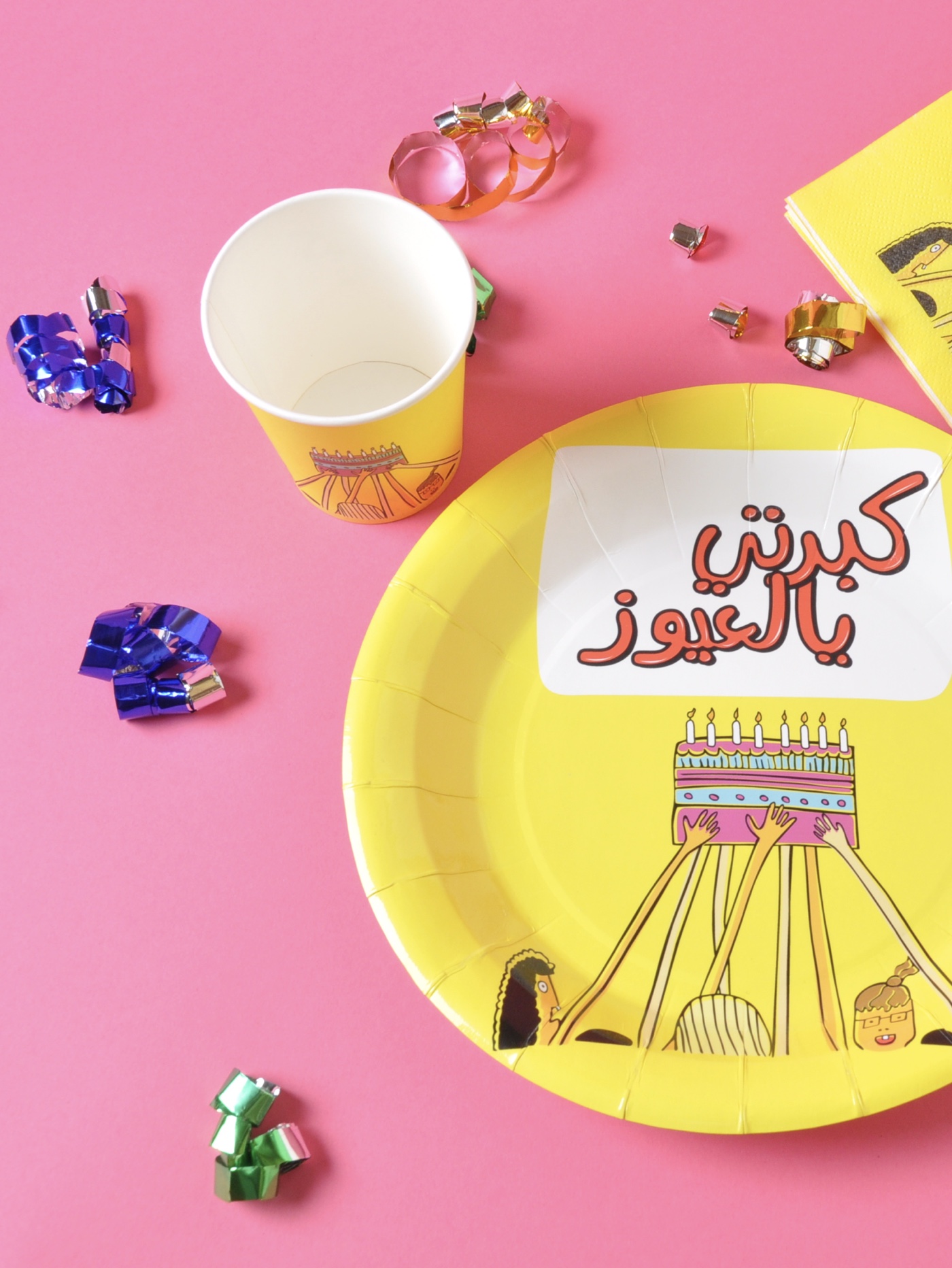 Colorful party supplies on pink background