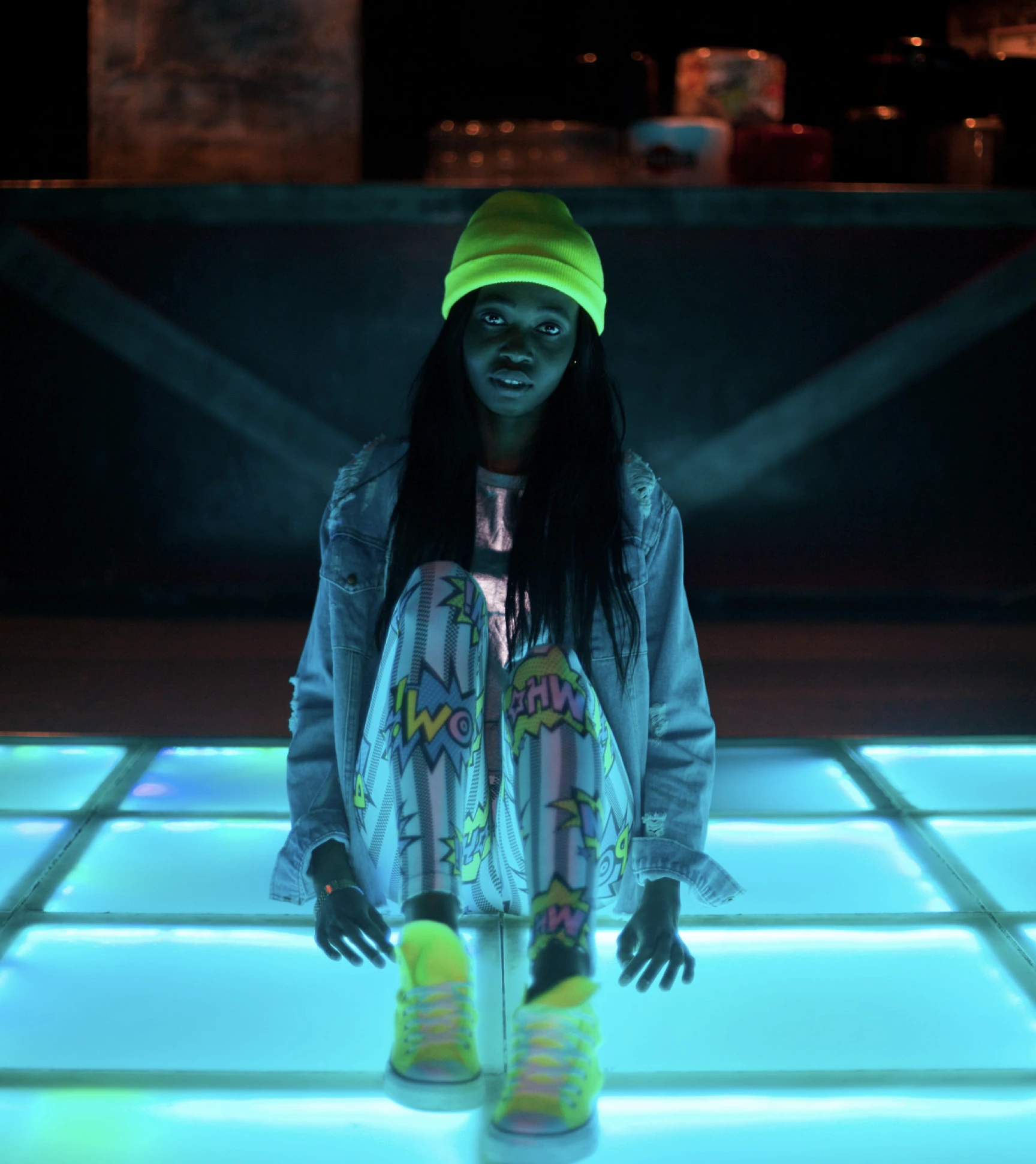Neon fashion on illuminated dance floor.